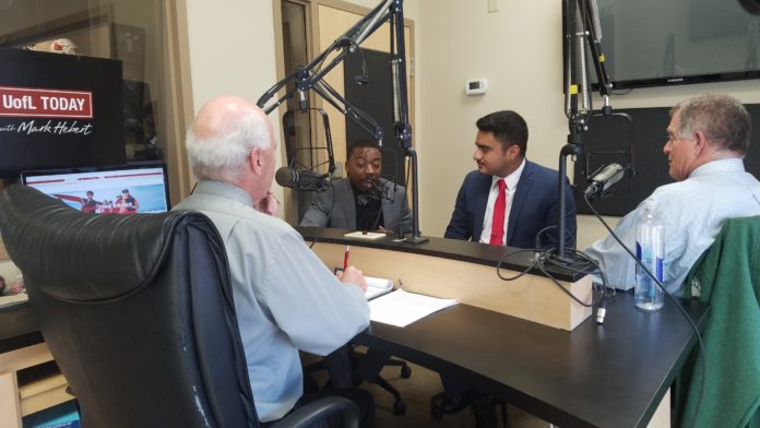 UofL students Elliott Kelly Jr., Lazaro Donis-Munoz and law professor Joe Gutmann