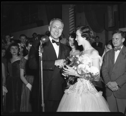 Taylor president University of Louisville president John W. Taylor shakes hands with homecoming queen Debbie Blair after presenting her award for being chosen in 1949. Photo courtesy of University Libraries Digital Collections.