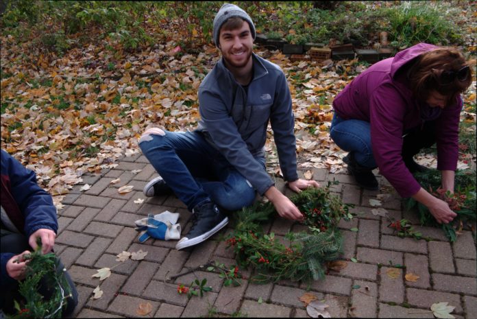 Student Nick Bremer shows off his holiday wreath.