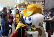 A student embraces Marshall Molar at MedFest