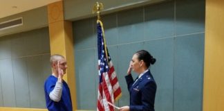 Andrew Aschbacher, doctor of nursing practice student at UofL, is commissioned into the Air Force by Maj. Angela Washington, a School of Nursing faculty member.