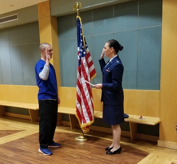 Andrew Aschbacher, doctor of nursing practice student at UofL, is commissioned into the Air Force by Maj. Angela Washington, a School of Nursing faculty member.