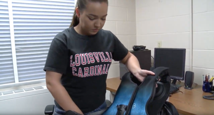 Briana Bonham takes out her vibrating vest which helps loosen built up fluids.