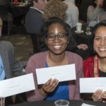 Three medical students hold their envelopes on Match Day.