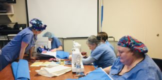 UofL Hospital employees making pillows, sleeping bags and totes from sterile wraps to be distributed at Wayside Christian Mission.