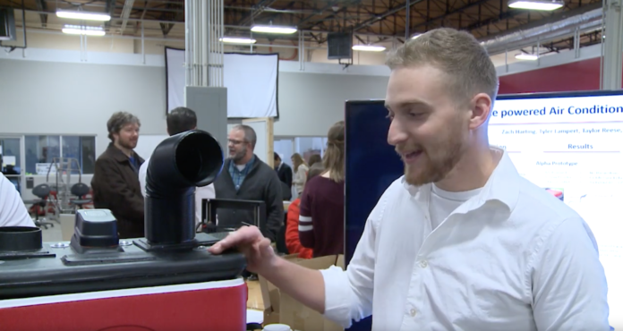 Mechanical engineering student Tyler Lampart presents his cooler-air conditioner prototype during Capstone showcase.