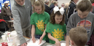 Young, future scientists play with a snow-like substance called sodium polyacrylate.