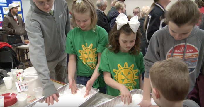 Young, future scientists play with a snow-like substance called sodium polyacrylate.