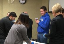 Participants in a Stop the Bleed training at UofL Hospital pack a simulated wound with gauze.