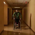 Spinal cord therapy research participant Jeff Marquis stands during therapy. Photo by Jessica Ebelhar.
