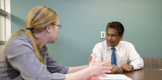 K.B. Kulasekera, Ph.D., talks with a student