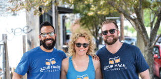 Three people, Dillon Miles, Danielle Huenefeld and Andy Huenefeld, standing together wearing sunglasses during a walking tour of Louisville.
