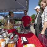 Customers shopping for produce at a farmers market