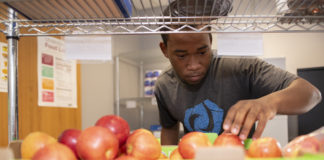 Bryant Grant, student volunteer at the Cardinal Cupboard.