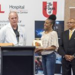Gunshot wound survivor Sheronda Morris Jasper presents the award to Brian Harbrecht, MD