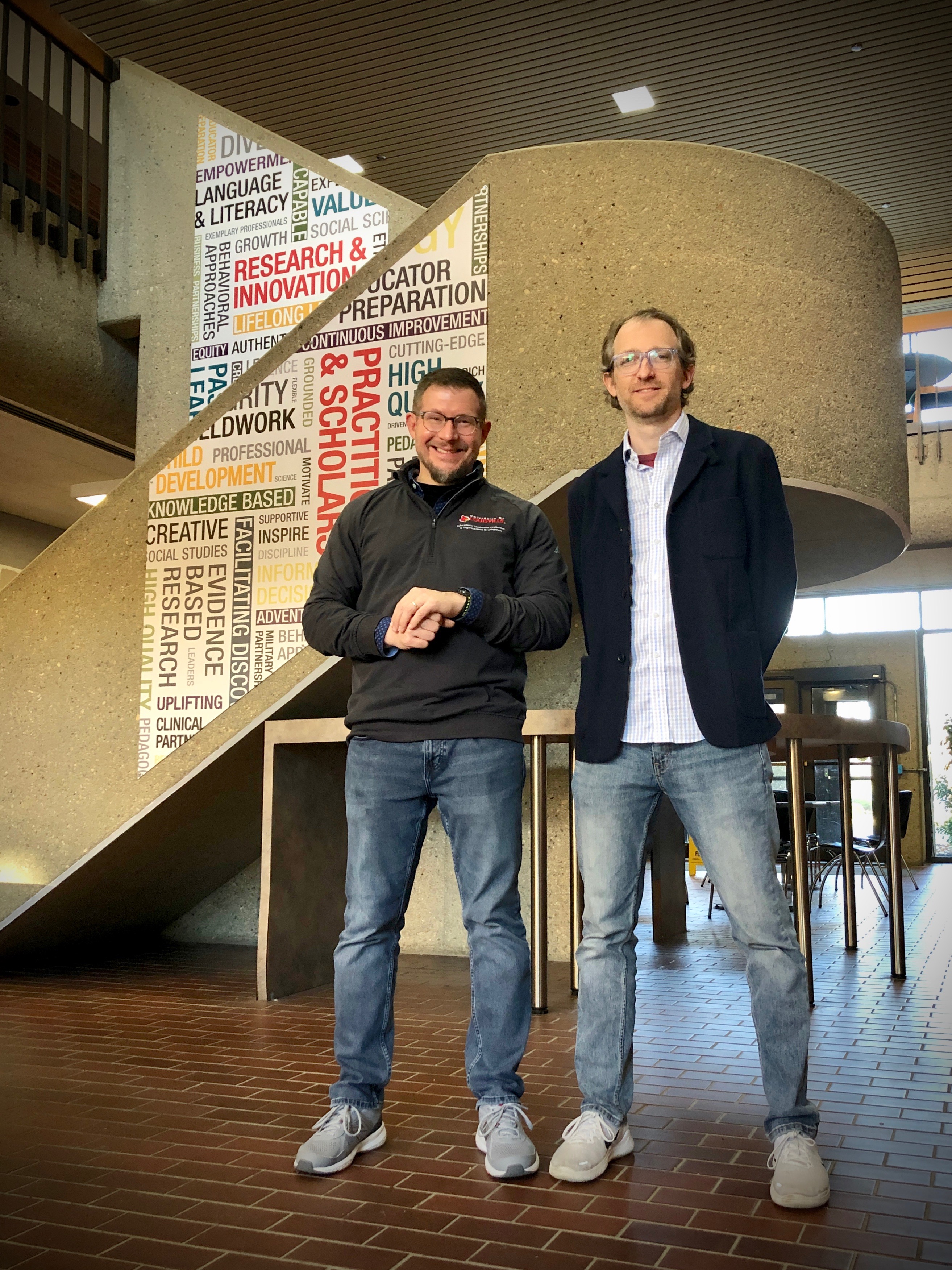 UofL researcher Brad Shuck (left) and entrepreneur Charley Miller (right) in the CEHD atrium