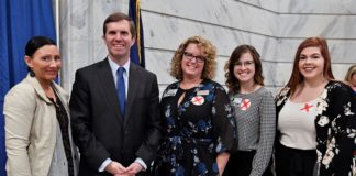 UofL researchers joined Gov. Andy Beshear at a Jan. 7 Capitol Rotunda news conference to raise human trafficking awareness. UofL graduate students Tara Sexton, Emily Edwards and Victoria Dobson are shown with Jennifer Middleton (center), associate professor of social work and director of the Human Trafficking Research Institute. Credit Timothy D. Easley.