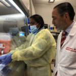 Julio Ramirez, M.D., right, in the UofL infectious diseases laboratory