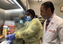 Julio Ramirez, M.D., right, in the UofL infectious diseases laboratory