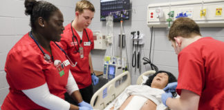 Undergraduate nursing students learn together in the simulation lab.