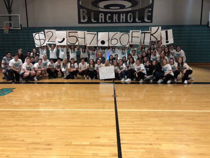 North Oldham students unveil their totals from last year's mini-marathon. This money goes toward UofL's raiseRED organization in the fight against pediatric cancer.