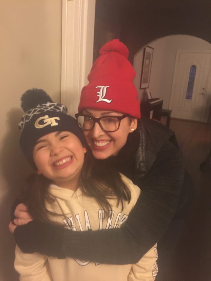 Master’s graduate Rachel Torres with 8-year-old daughter Isvara.