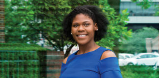 Keionna Bailey, standing in front of greenery