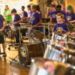 Elementary students play percussion instruments