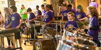 Elementary students play percussion instruments