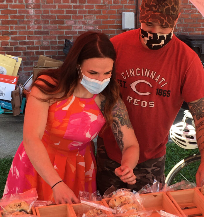 2017 alumna Abigail Mattingly and fiancé Griffin McGreevy sell their Bourbon Baekery cookies alongside the Logan Street Market.