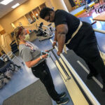 patient undergoes physical therapy in a hospital rehab room