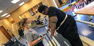 patient undergoes physical therapy in a hospital rehab room