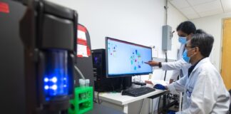 Two scientists at a computer workstation