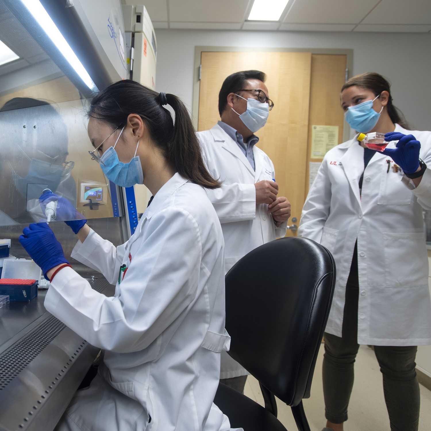 Jun Yan, M.D., Ph.D., director of the UofL Center for Cancer Immunology and Immunotherapy (center) with graduate student Yunke Wang (left) and MD/PhD student Anne Geller.