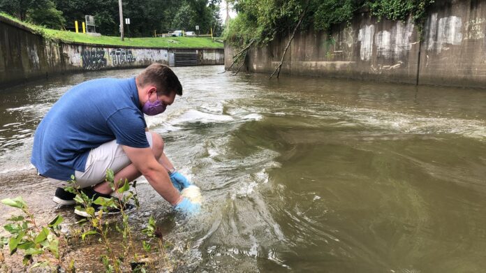 UofL student Sam Kessler using the water testing tool