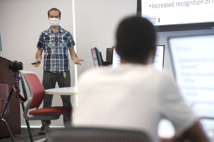 David A. Johnson, Ph.D., M.P.H., C.P.H., engages students in a socially distanced classroom