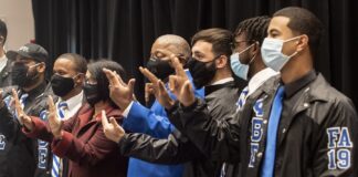 Students and university administrators celebrate the unveiling of National Pan-Hellenic Council markers on the Belknap Campus.