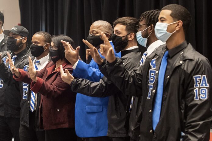 NPHC_1133 Students and university administrators celebrate the unveiling of National Pan-Hellenic Council markers on the Belknap Campus.