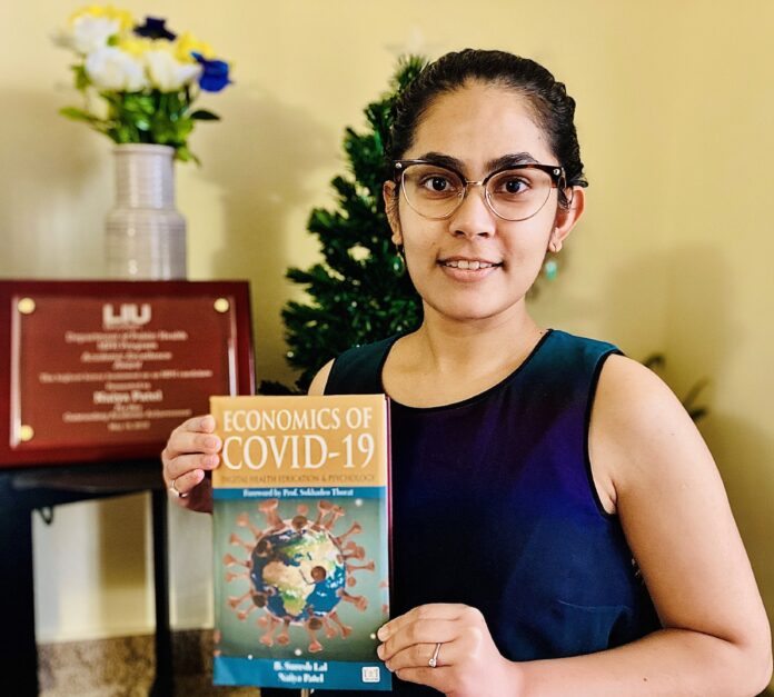 economics of COVID-19 Naiya Patel holding her new book