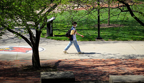A student walks across campus.