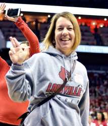 Kathryn Klope vanTonder smiles on the sideline of the practice field at UofL's spring football game.