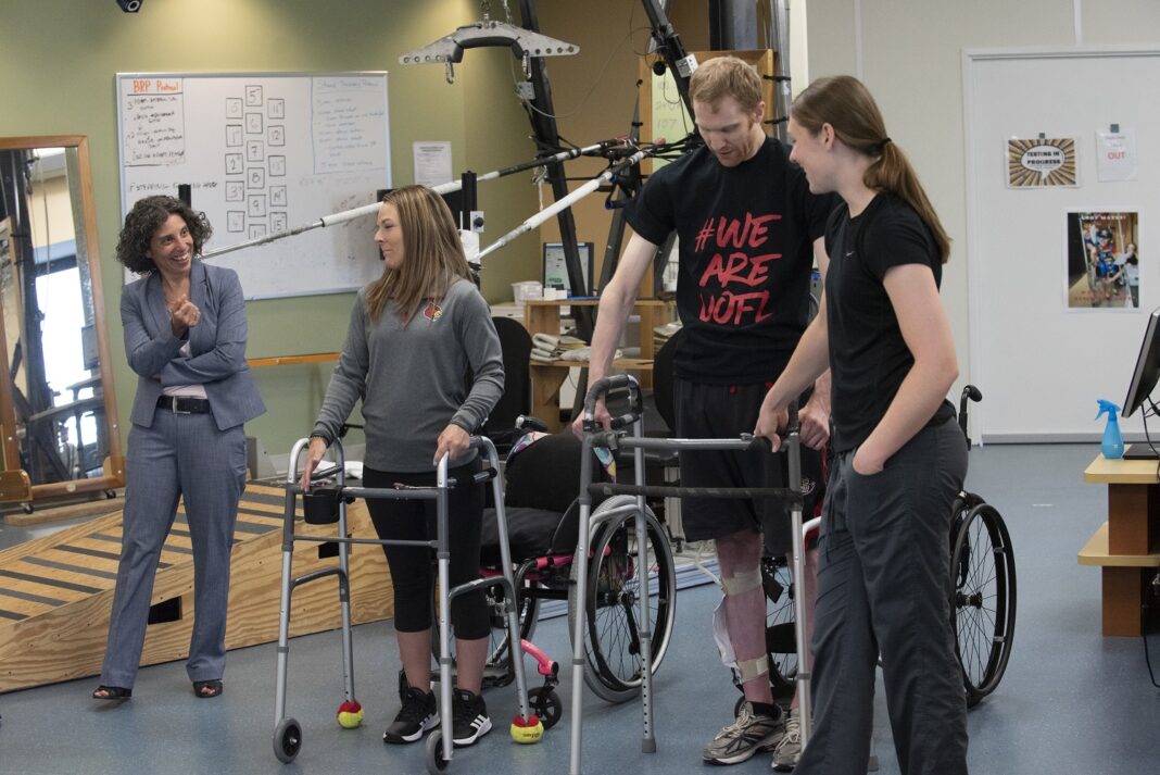 Claudia Angeli, Ph.D., left, with UofL research participants Kelly Thomas and Jeff Marquis and trainer Kristin Benton