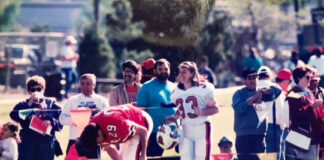 Kathryn Klope vanTonder smiles on the sideline of the practice field at UofL's spring football game.