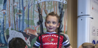 Malcolm MacIntyre, a patient at the Kosair Charities Center for Pediatrc NeuroRecovery, uses the specially designed pediatric treadmill for children.