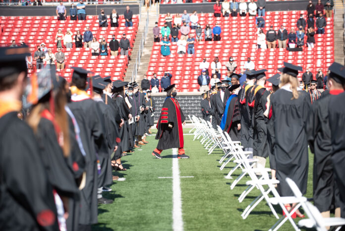 President Neeli Bendapudi walks past 2020 and 2021 graduates