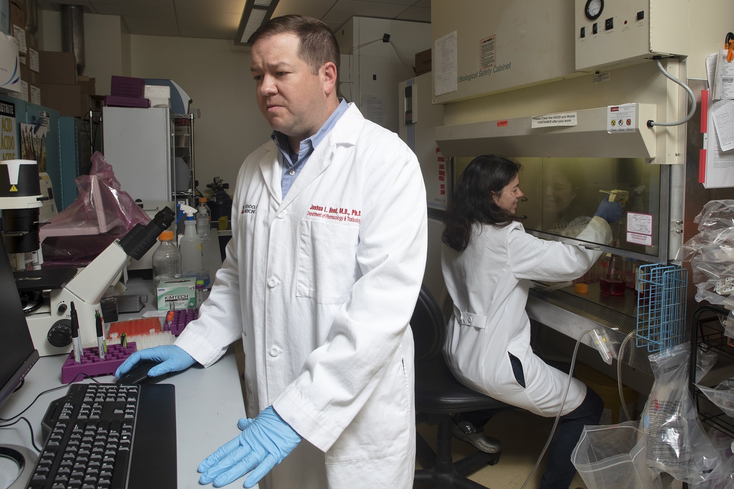 Craig McClain, M.D., right, with Matthew Cave, M.D., liver researcher and H&T COBRE core director, center, and Jamie Young, Ph.D., using equipment known as the NanoDrop instrument to analyze RNA and DNA samples.