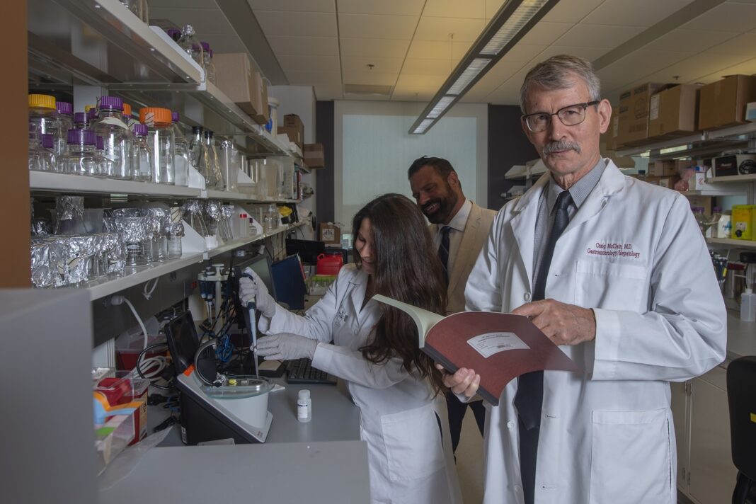 Craig McClain, M.D., right, with Matthew Cave, M.D., liver researcher and H&T COBRE core director, center, and Jamie Young, Ph.D., using equipment known as the NanoDrop instrument to analyze RNA and DNA samples.