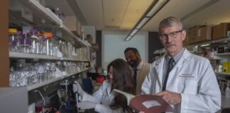 Craig McClain, M.D., right, with Matthew Cave, M.D., liver researcher and H&T COBRE core director, center, and Jamie Young, Ph.D., using equipment known as the NanoDrop instrument to analyze RNA and DNA samples.