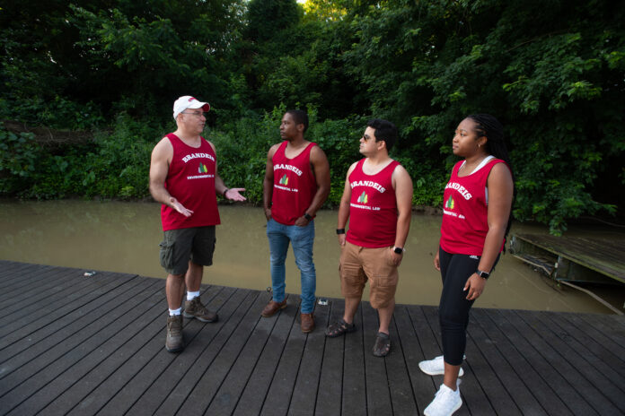 Law professor Tony Arnold talks with law students Cameron Lyons, Frank Bencomo and Lauren Neal