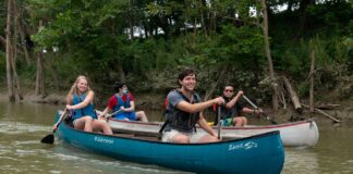 University of Louisville honors students Forest Clevenger (leading the blue canoe) Vinh Pham (leading the white canoe) paddle the Ohio River as part of a class that investigated how river towns can drive tourism and economic development. Photo courtesy John Nation.
